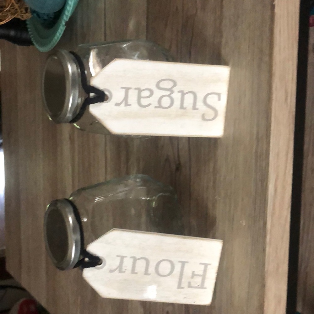 Clear glass cute little container that say sugar and flour